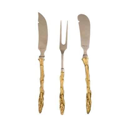 Set of three silver knives with gold handles on a black background