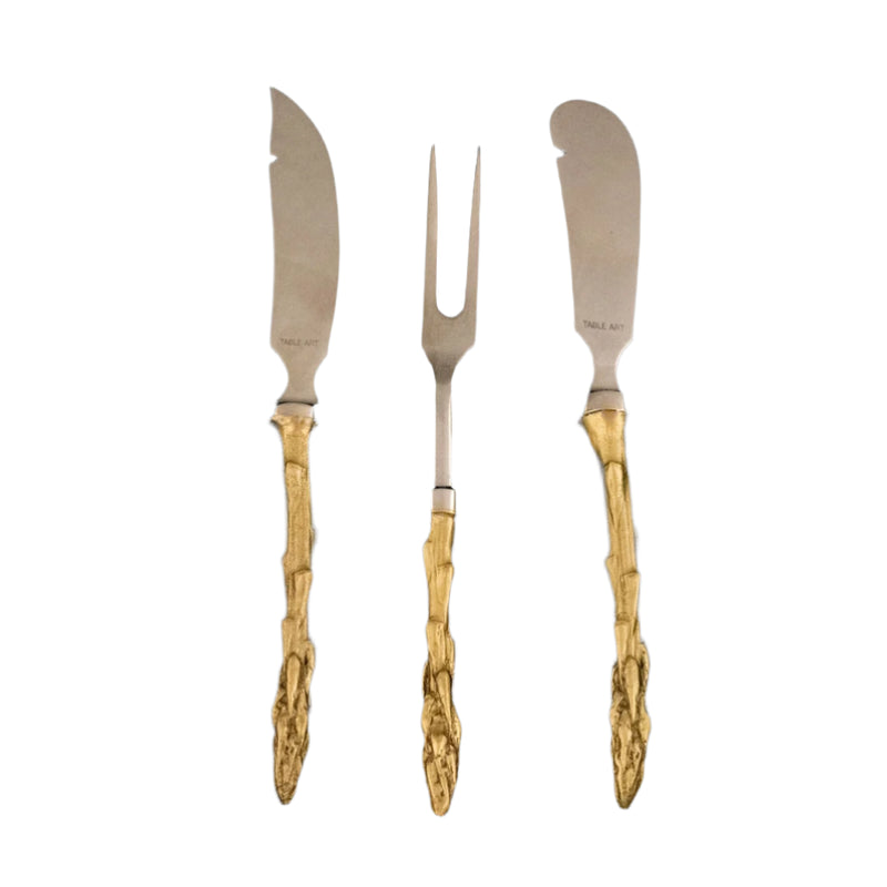 Set of three silver knives with gold handles on a black background